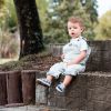 a photo of a young child sitting on a stone bench at Fertility Argentina clinic